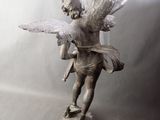 a statue of a little boy with wings on a pedestal