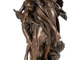 a bronze statue of a woman holding a child on a rock
