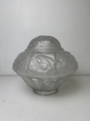a glass jar with a lid on a white surface