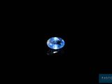 a close up of a blue sapphire on a black surface