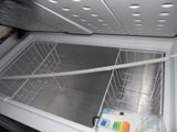an open refrigerator with the door open and a bottle of water in it