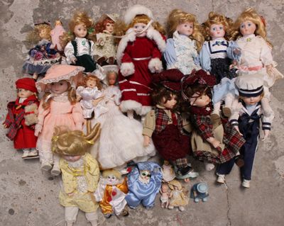 a lot of dolls that are sitting on the ground