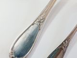 two spoons sitting next to each other on a table