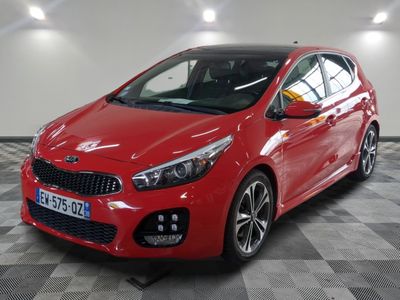 the red car is parked in the garage on a checkered floor