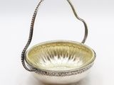 an antique silver plate with a handle and handle on a white background