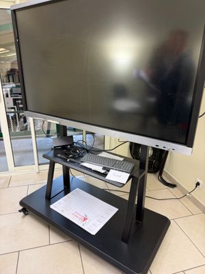 a flat screen tv sitting on a stand in a room