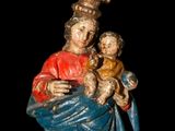 an image of a statue of a woman holding a child and wearing a crown
