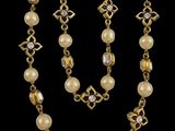 a gold and pearl necklace and bracelet set