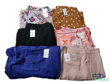 four pairs of women ' s pants with a price tag on a white background