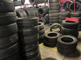 a lot of tires that are stacked up in a warehouse