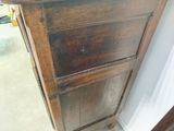 a wooden cabinet with a drawer on top of it