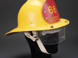 a close up of a yellow fireman ' s helmet on a mannequin head