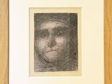 a black and white drawing of a man ' s face in a wooden frame