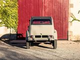 a old car parked in front of a red door