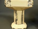 a white pedestal with a bowl on top of it