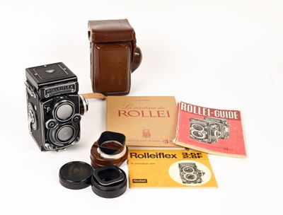 a rolleiflex camera, a rolleiflex book, and a rolleiflex film camera