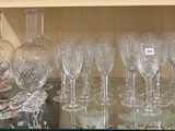 a glass shelf with a lot of wine glasses on it