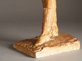 a sculpture of a woman holding a bird on a stand