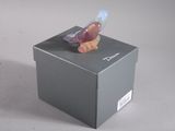 a small bird that is sitting on top of a box