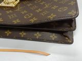 a brown and gold purse with a chain on top of it