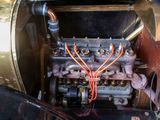 a close up of an old car engine with wires attached to it
