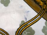 a close up of a table cloth with a clock on it