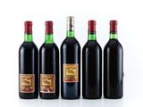 four bottles of red wine are lined up in a row