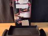 a box that has a grill in it on a table
