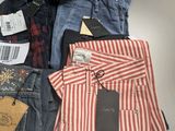 several pairs of men ' s jeans are laid out on a table