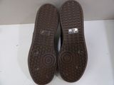 pair of brown slippers sitting on top of a white surface
