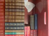 many books in a red box on the shelf