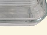 a clear glass casserole dish on a white surface