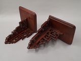 two wooden bookends with intricate carvings on them