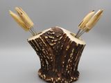 wooden utensils in a tree stump holder on a gray background