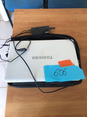 a laptop computer sitting on top of a wooden table