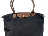 a black and brown handbag with a brown handle