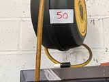 a black and yellow hose on top of a shelf