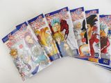 six dragon ball books are lined up on a white surface