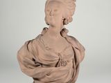 sculpture of a bust of a woman with a shaw around her neck