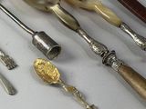 many different types of spoons and utensils laid out on a table