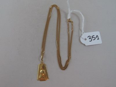 une image représentant un collier en or auquel est suspendue une clochette