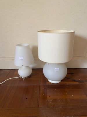 two lamps that are sitting on the floor next to each other