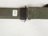 a close up of a knife with a tag on it