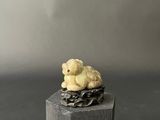 figurine of two teddy bears sitting on top of a wooden block