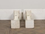 two white wooden benches sitting next to each other on a wooden floor