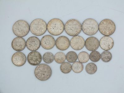 some old silver coins are arranged on a white surface