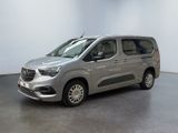 the silver van is parked in a room with a white wall