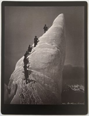 photographie en noir et blanc représentant un groupe de personnes escaladant une montagne