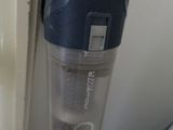 a vacuum that is sitting on the floor next to a window