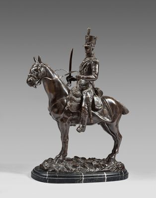 a bronze statue of a man on a horse with a sword